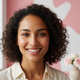 Close-up portrait of a smiling woman with radiant, even-toned skin, representing a happy customer.